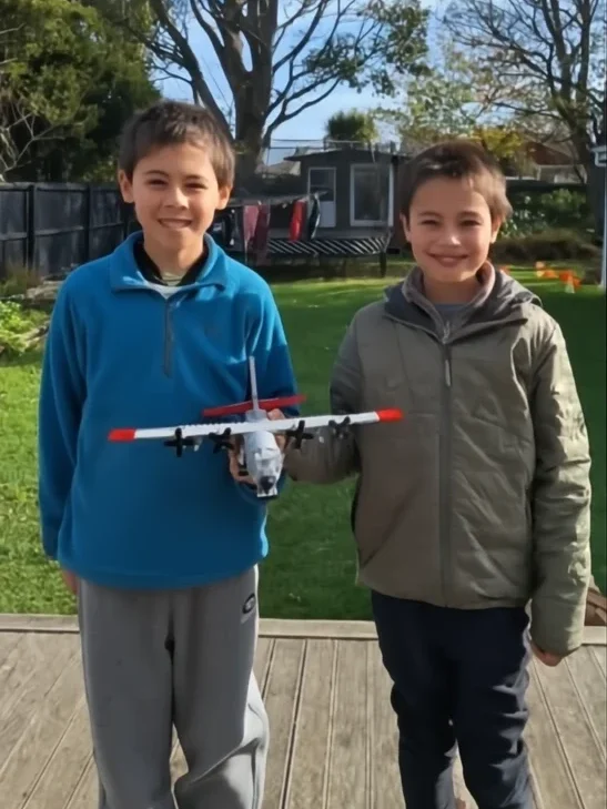 Joshua and Caleb, young air traffic control enthusiasts, with a USAF C130 Ski Hercules model.